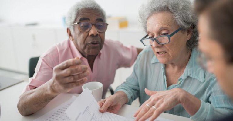 Advisors - Two Seniors Looking at Papers