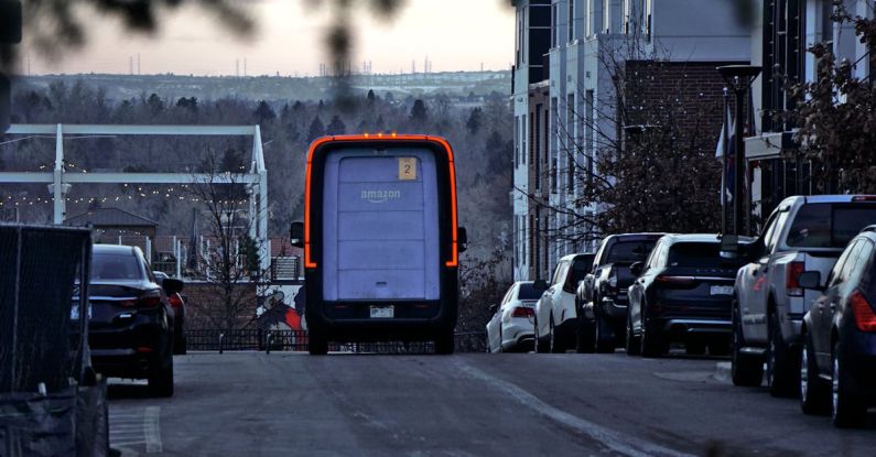 Reselling - A truck is driving down a street with cars parked on the side